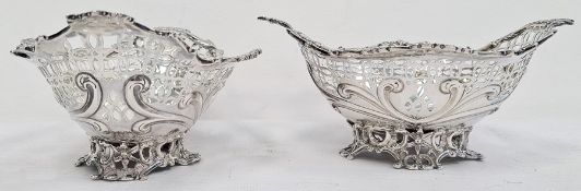 Pair of Victorian silver foliate decorated and pierced bonbon dishes raised upon four pierced