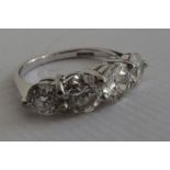 18ct white gold diamond four-stone ring, set with round brilliant-cut and old-cut diamonds (