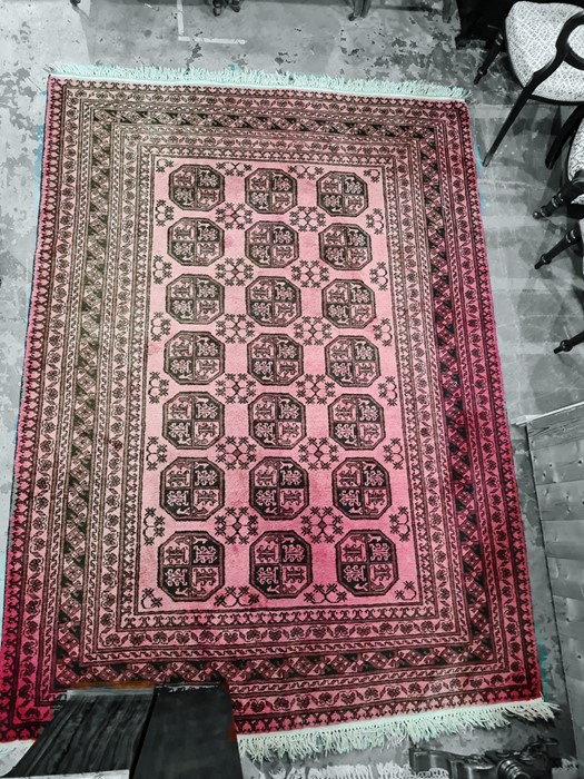 Persian rug with 21 elephant foot guls to the red ground field, stepped border, 270cm x 195cm