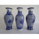 Near pair of Chinese porcelain baluster vases with underglaze blue decoration of flowerheads, on a