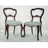 Set of four Victorian rosewood dining chairs with carved top rails, carved and pierced bar backs,