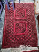 Eastern rug, red ground with two central medallions, on a stepped border, 166cm x 96cm