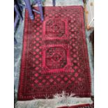 Eastern rug, red ground with two central medallions, on a stepped border, 166cm x 96cm