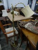 Modern brass floorstanding lamp with cream-coloured shade and four lampshades