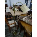 Modern brass floorstanding lamp with cream-coloured shade and four lampshades