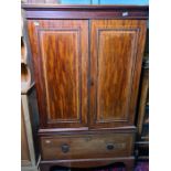 19th century mahogany and satinwood banded linenpress with two doors opening to reveal linen