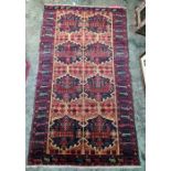 Persian rug, blue ground with assorted motifs, in peaches, reds, blues and greens, 180cm x 105cm
