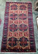 Persian rug, blue ground with assorted motifs, in peaches, reds, blues and greens, 180cm x 105cm