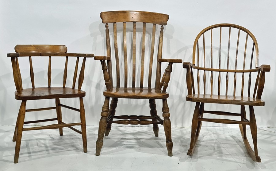 Elm seated captain's type chair, a modern comb-back rocking chair and one further armchair (3)