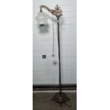 Brass floor standing light with opaque glass shade