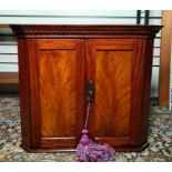 19th century wall-hanging mahogany two-door corner cabinet, 50.5cm high