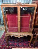 Early 20th century display cabinet with two glazed doors, raised on cabriole legs, 86.5cm x 156cm