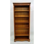 20th century yew open bookcase raised on bracket feet, 78cm x 181.5cm