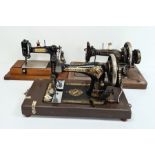 Three various sewing machines, with cases(3)