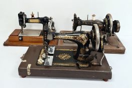 Three various sewing machines, with cases(3)