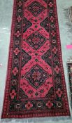 Eastern runner with four central medallions in red and black, 286 x 76 cm