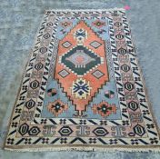 Persian rug with central medallion, stepped border, the whole in creams, blues, peaches and yellows,