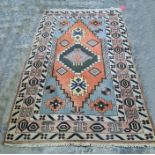 Persian rug with central medallion, stepped border, the whole in creams, blues, peaches and yellows,