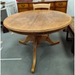 Circular pine breakfast table on turned pedestal to three cabriole legs, 121cm diameter