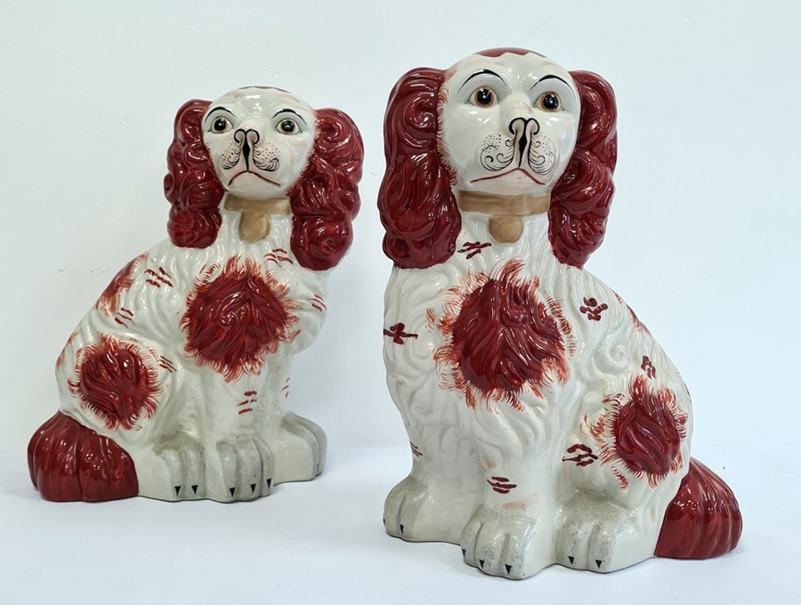 Pair Holkham pottery Staffordshire-type model spaniels with russet colouring, 32cm high (2)