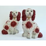 Pair Holkham pottery Staffordshire-type model spaniels with russet colouring, 32cm high (2)