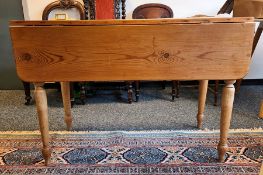 20th century pine drop-leaf table on turned supports to peg feet