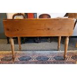 20th century pine drop-leaf table on turned supports to peg feet