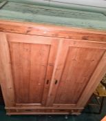 Late 19th century pine wardrobe with two large doors enclosing hanging space, with two short drawers