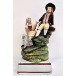 Early 19th century Staffordshire pearlware group of milkmaid and companion, on grassy mound base and