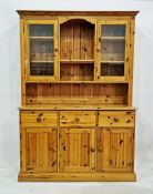 20th century pine dresser with moulded pediment above open shelves flanked by glazed doors, the base