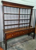 18th century oak dresser with ogee moulded pediment, open platerack above the base of three drawers,