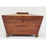 19th century mahogany sarcophagus-shaped tea caddy, the hinged top opening to reveal compartmented