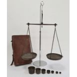 Set of scales and brass weights in leather suitcase