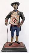 A painted metal travelling figure with painted clock to his front, Roman numeral dial with painted