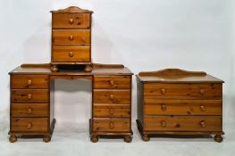 20th century pine dressing table, a chest of three drawers and a beside chest of three drawers (