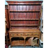 Possibly 18th century oak dresser, the moulded pediment above open shelves, the base with two