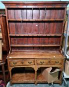 Possibly 18th century oak dresser, the moulded pediment above open shelves, the base with two