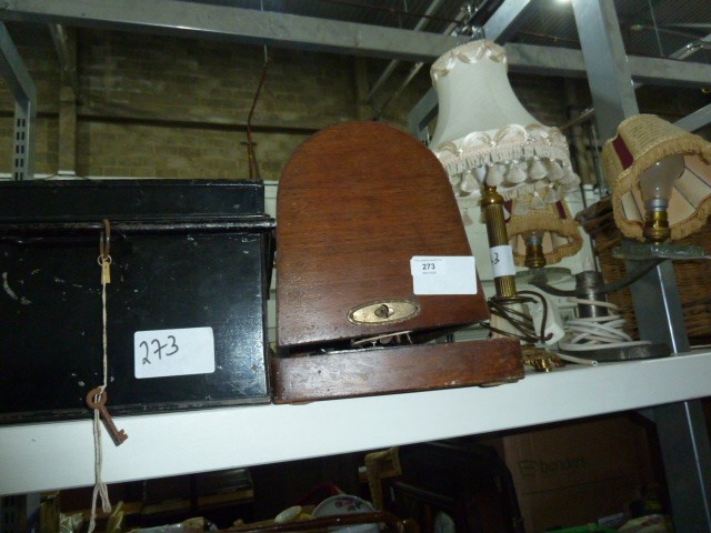 Small black metal trunk with key, a sewing machine, a brass table lamp and a metal and glass twin