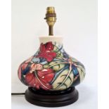 Moorcroft pottery table lamp, squat baluster shape and having tube-lined hibiscus decoration,