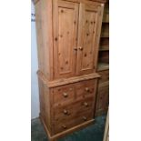 20th century pine tallboy with ogee moulded pediment, two cupboard doors enclosing hanging space,
