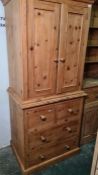 20th century pine tallboy with ogee moulded pediment, two cupboard doors enclosing hanging space,