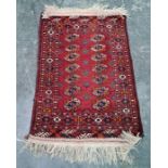 Persian rug with two rows of seven elephant foot guls, stepped border, 120cm x 82cm