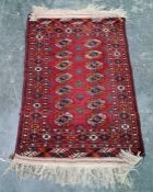 Persian rug with two rows of seven elephant foot guls, stepped border, 120cm x 82cm