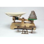 Pair of brass postal scales and a set of cream and green painted balance scales (2)