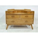 Mid century oak dressing table, the rectangular top with curved recess, the base with two drawers