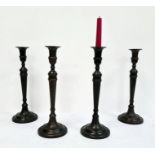 Set of four bronze-effect table candlesticks