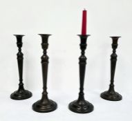 Set of four bronze-effect table candlesticks