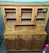 Late 19th/early 20th century pine dresser with ogee moulded pediment above three glazed doors