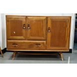 Light elm Ercol sideboard with three cupboard doors and single drawer, raised on turned beech