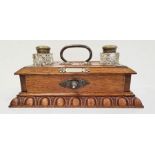 Late 19th century oak desktop inkwell with a pair of cut glass ink bottles with brass mounts and